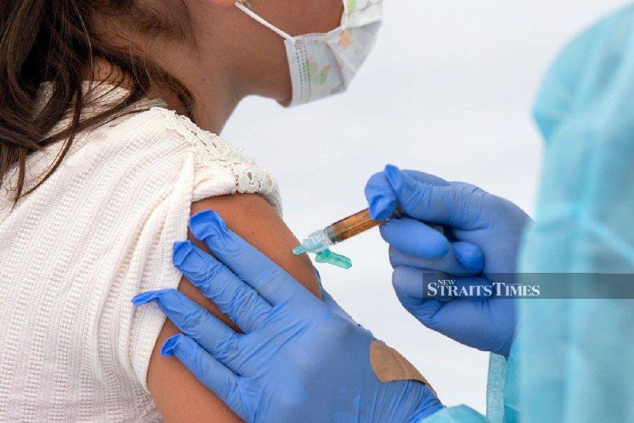 Parents have given mixed reactions over the latest move to have children aged between 5 and 11 vaccinated against Covid-19. - AFP pic. 