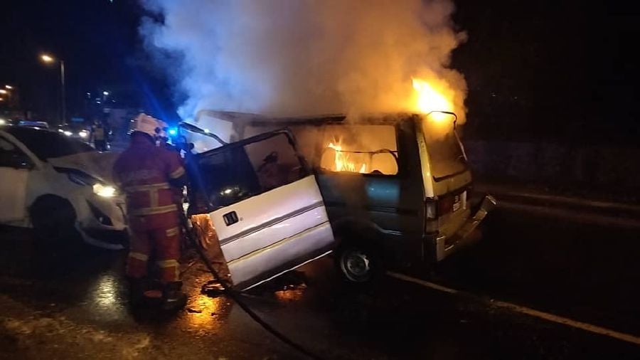 A family of four escaped fiery death when the van they were travelling in burst into flames in a road accident at Jalan Tunku Abdul Rahman here at around midnight. - Pic courtesy of Bomba