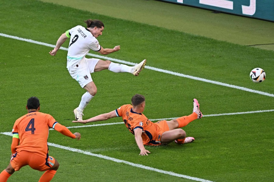 Austria's midfielder #09 Marcel Sabitzer scores his team's third goal during the UEFA Euro 2024 Group D football match between the Netherlands and Austria at the Olympiastadion in Berlin on June 25, 2024. -- AFP