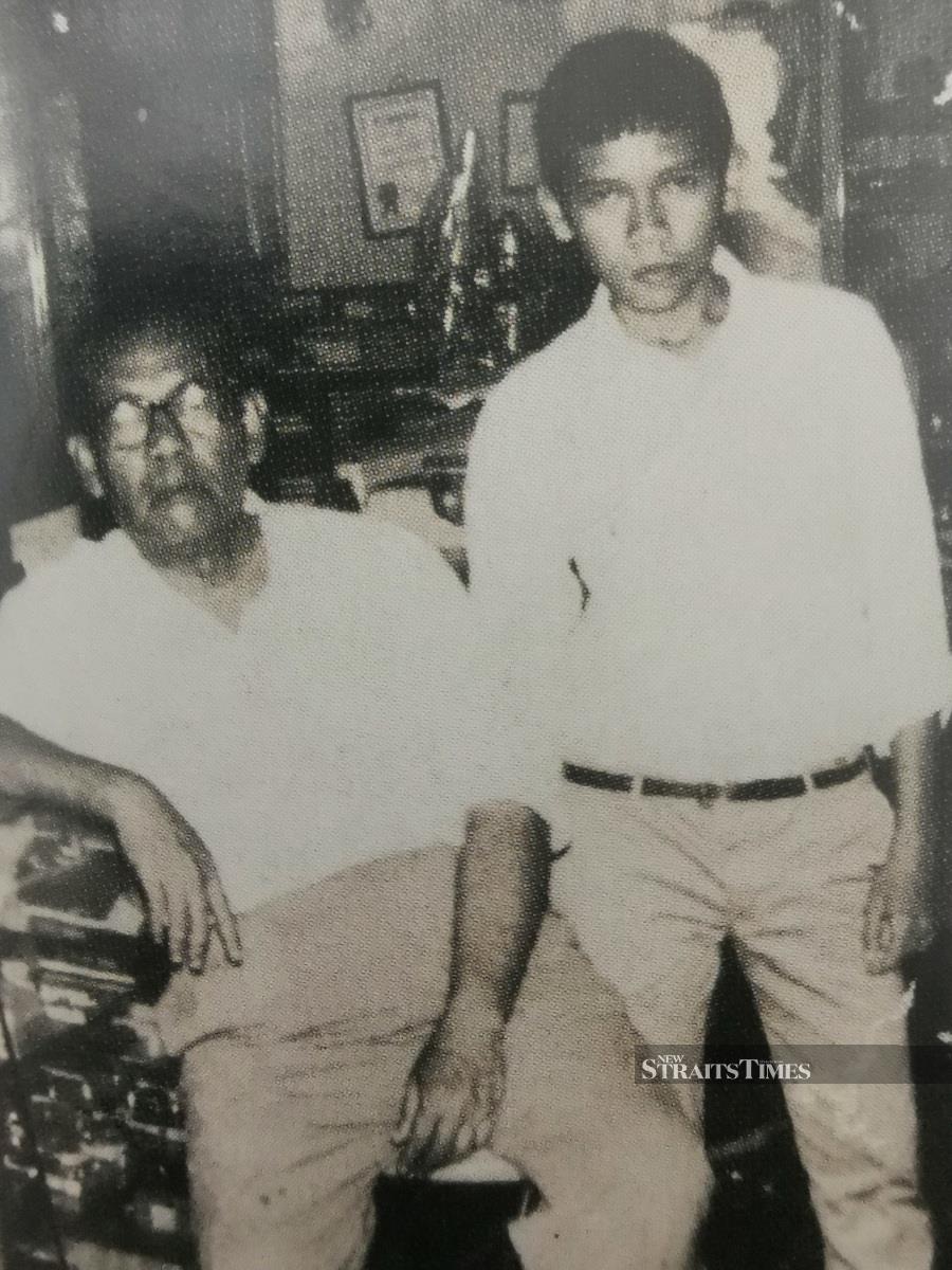  With his father at a camera shop in Ipoh in 1968.