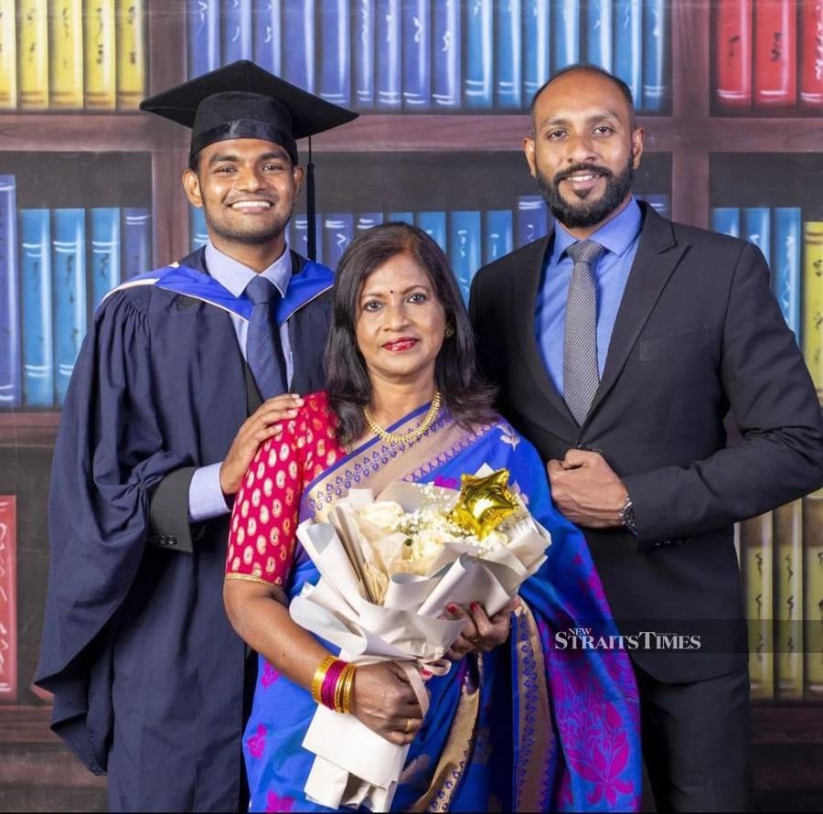  With his proud mother and brother on his graduation day.