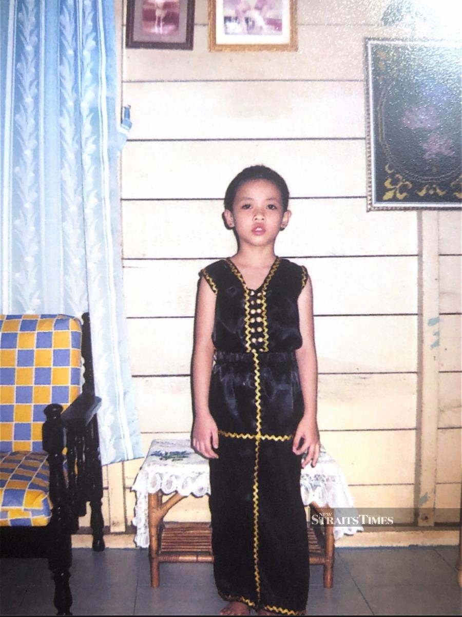  Elvira as a young girl donning Kadazan traditional attire.