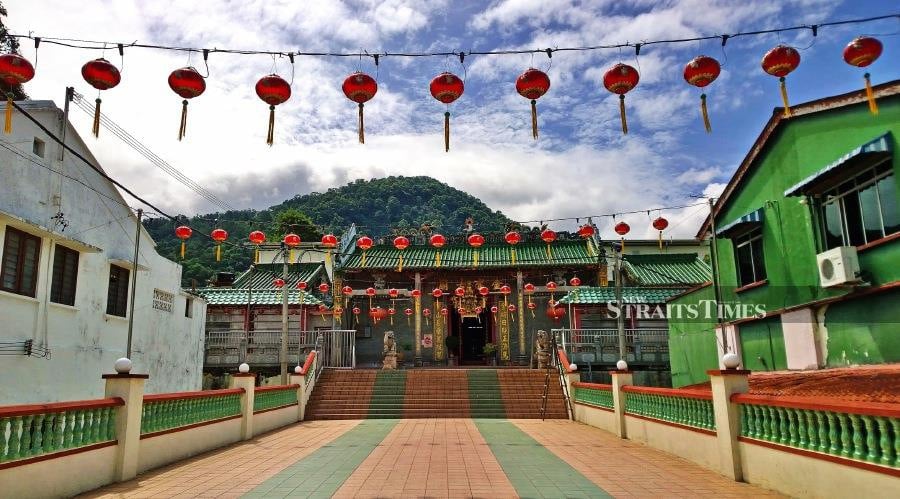  120-year-old Kampar Gu Miao Temple with the hill behind it.
