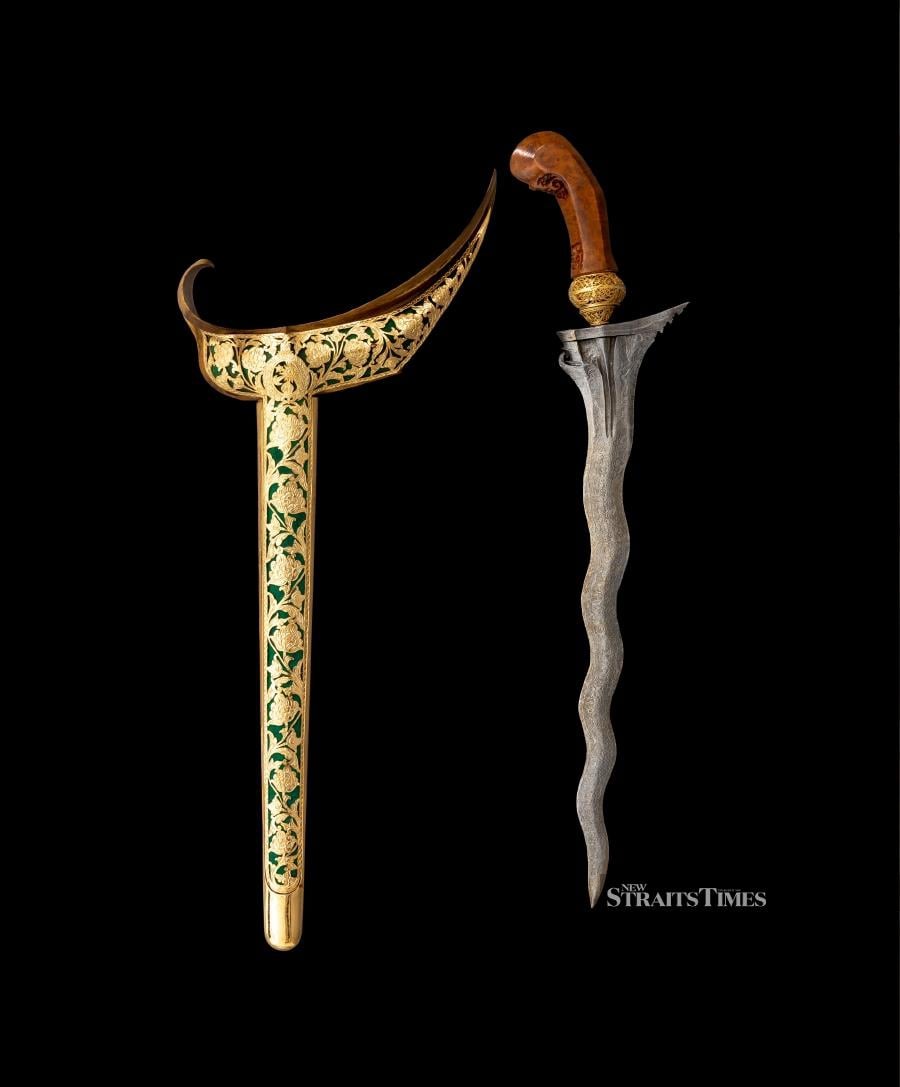  A 19th-century Javanese keris with a wonderfully watered blade and elaborate scabbard. Collection of HRH Sultan Sharafuddin Idris Shah.