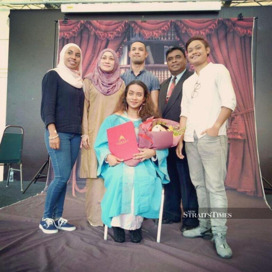  Nad with her family during her diploma graduation day in Aswara.