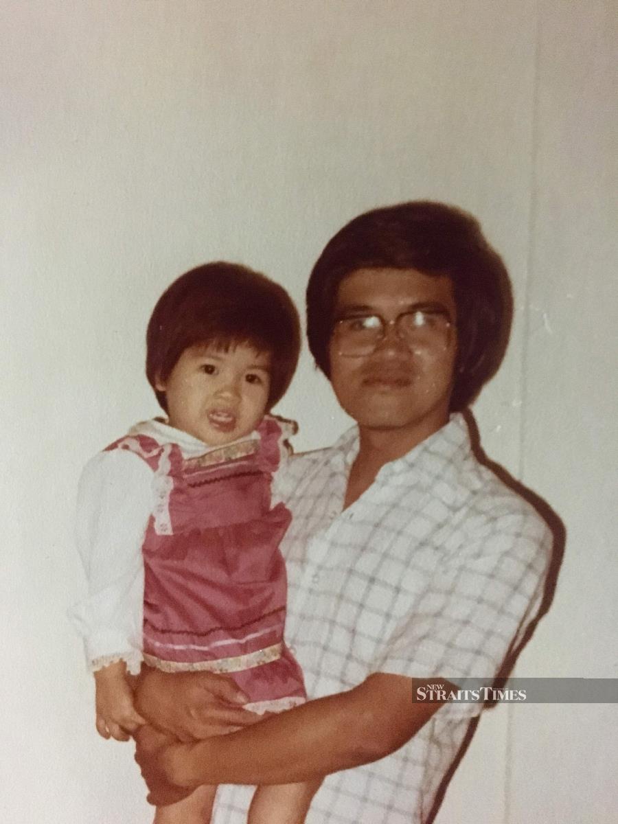  Dora in her artist-father's arms as a kid.