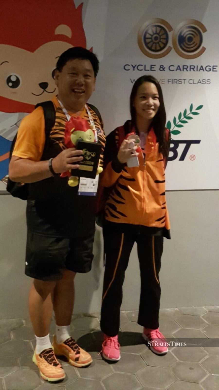  Lim with her coach, Loke Chee Heng.