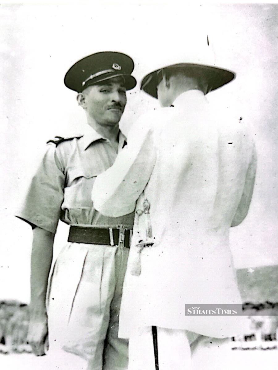  Receiving the Colonial Police Medal for Gallantry by Sir Edward Gent.