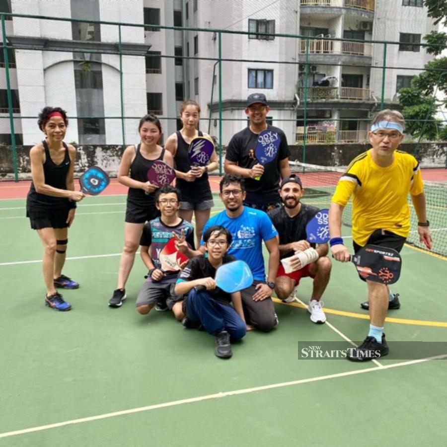  In 2022, the duo were introduced to pickleball in Kuala Lumpur by Ted Thor (in yellow) and Rose Ibrahim (far left) and their journey began.