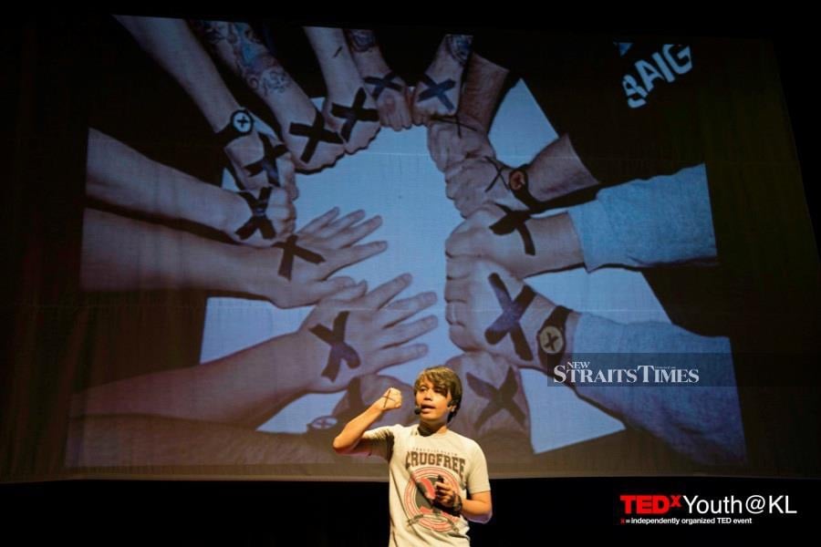  Khai Aziz speaking at a TEDx event.