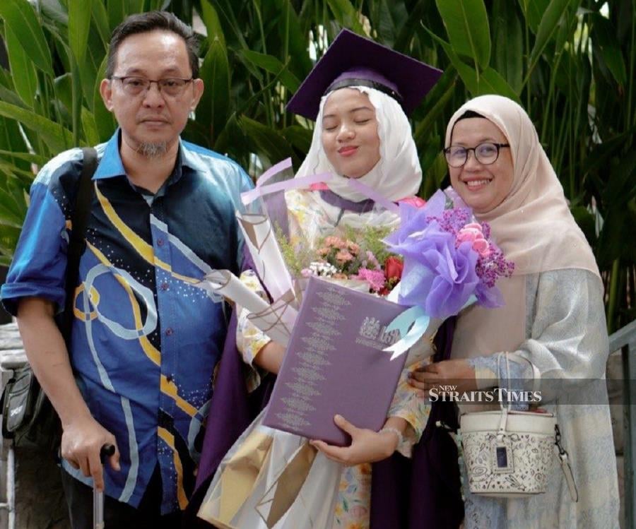  Graduation day was a proud moment for Wina and her parents.