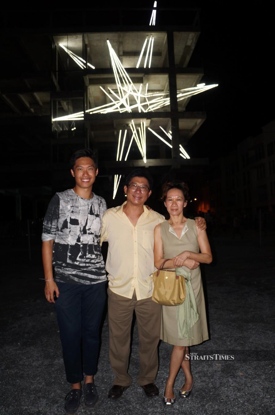  Jun and his proud parents at his five-storey light installation in Penang back in 2015.