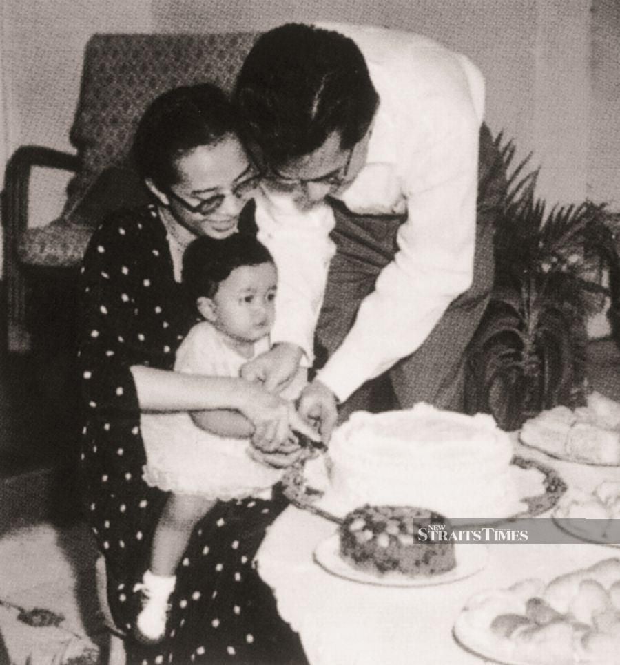  One-year-old Marina and her beaming parents.