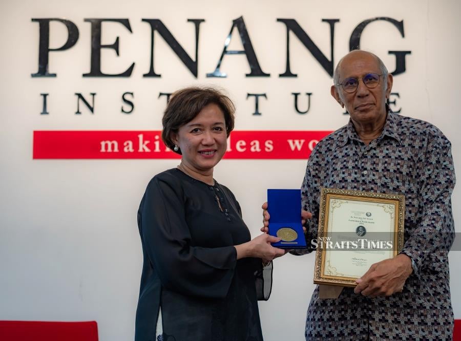  Prof. Datuk Dr Adeeba Kamarulzaman receiving an award from Datuk Seri (Dr) Anwar Fazal, president of the Dr Wu Lien-Teh Society. Photo by David Loh ST.