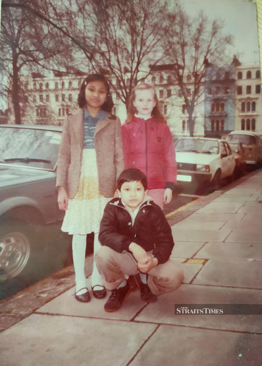  Intan (left), her best friend Henrietta and her brother during her primary school days in England.