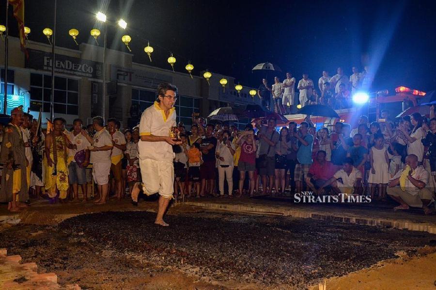  The writer participating in the fire-walking ceremony during the Nine Emperor Gods Festival a few years ago. Picture by Tan Bok Hooi.