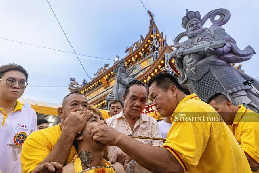  A medium preparing for the third day procession during the Nine Emperor Gods Festival. Picture by Allen Lim Lean Eng.
