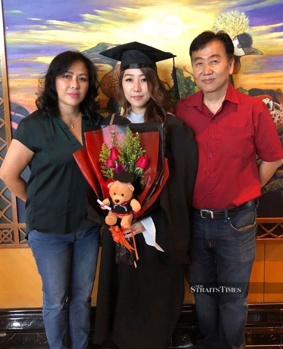  Graduation day with her proud parents.