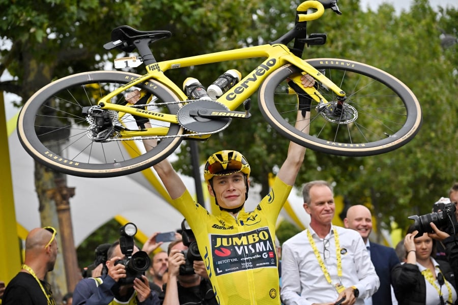 Jonas Vingegaard lifts his bike as he celebrates winning the Tour de France stage 21 last year. - REUTERS PIC