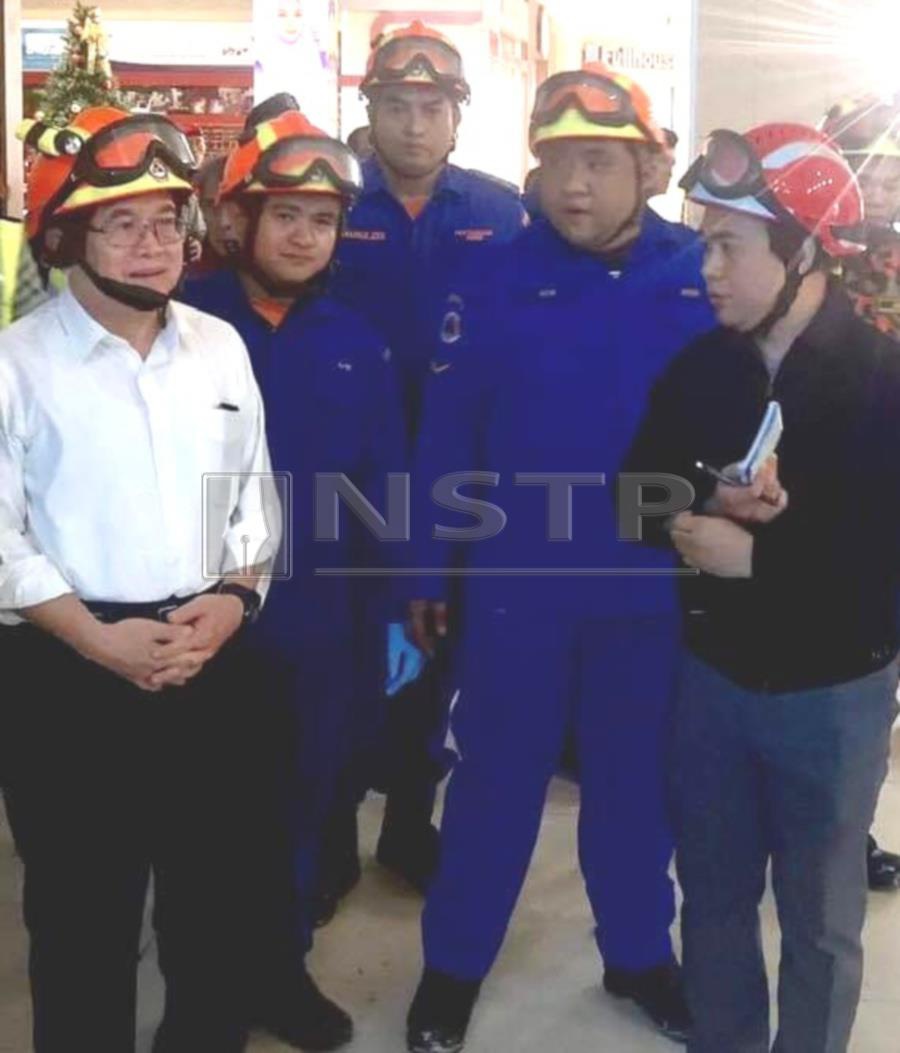 Deputy Chief Minister Datuk Amar Douglas Uggah Embas (left) inspects the damage at the CityOne Megamall in Kuching. -NSTP/MELVIN JONI