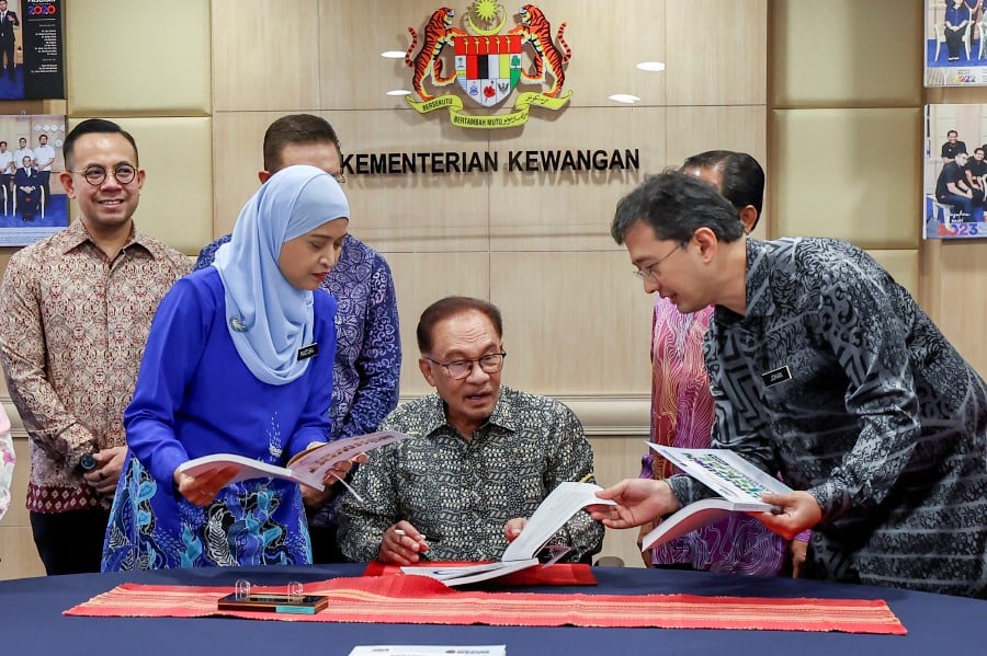 Treasury secretary-general Datuk Johan Mahmood Merican (right) said removing all subsidies at once would increase the cost of living and stunt the growth of businesses and investments in the nation.