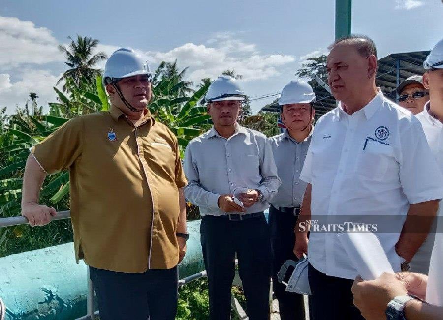 Sabah Public Works minister Datuk Shahelmey Yahya (left) visiting the Limbahau Raw Water Intake plant. - NSTP/OLIVIA MIWIL