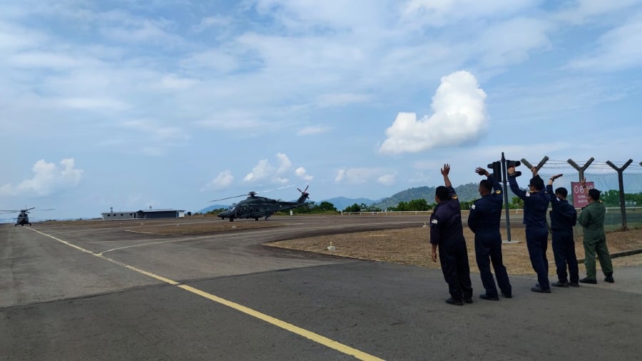 Five members of the Royal Malaysian Navy 503 Squadron wave to the crew of the two AW139 Maritime Operations Helicopters as they depart for the Lumut naval base recently. Picture taken from the 503 Squadron's Facebook page
