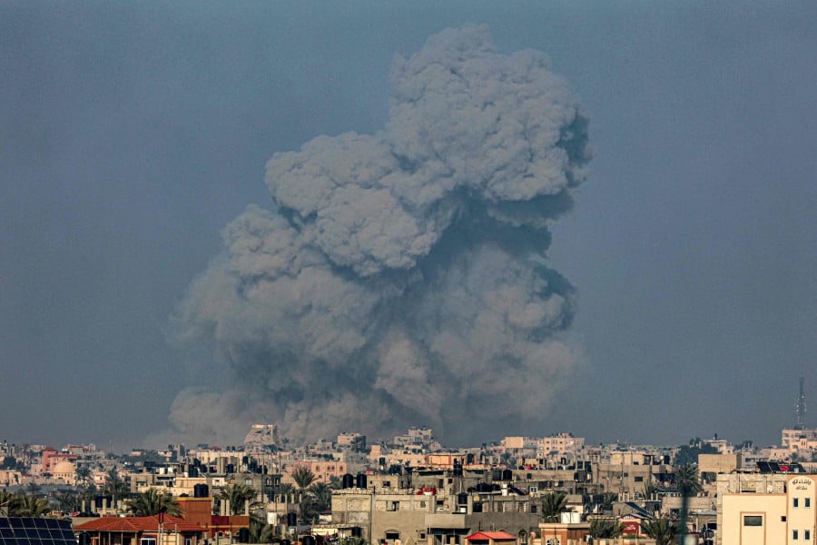 A picture taken from Rafah shows smoke billowing over Khan Yunis in the southern Gaza Strip during Israeli bombardment. - AFP PIC