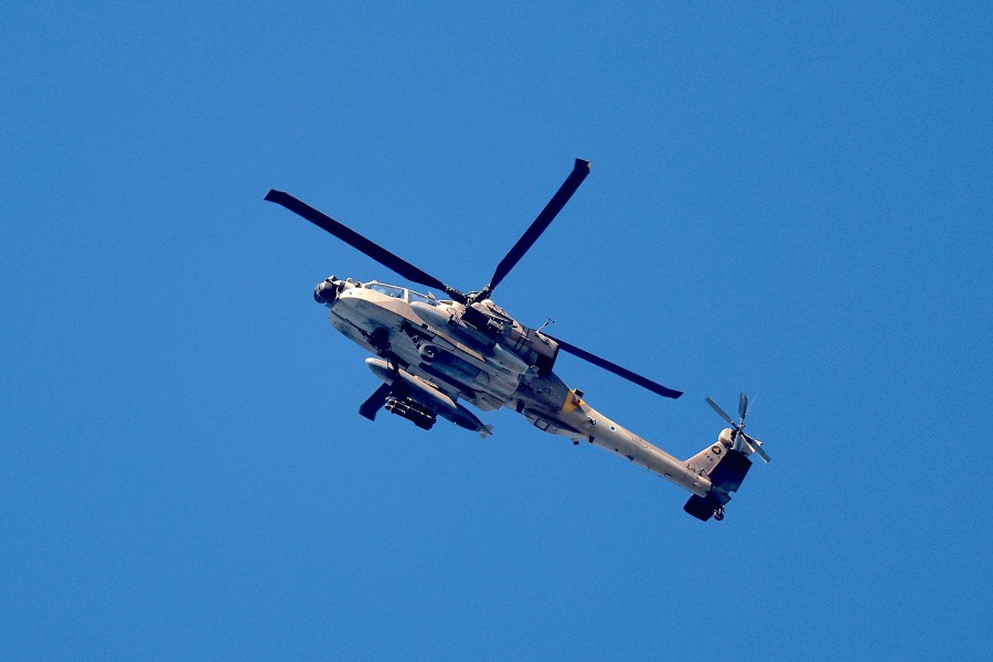 A picture taken from southern Israel shows an Israeli army helicopter flying along the Gaza Strip. - AFP PIC