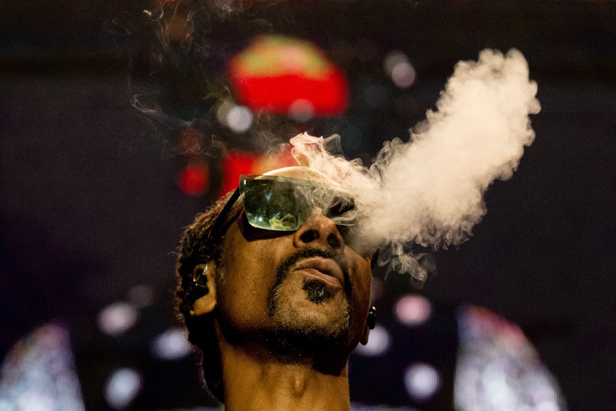 US rapper Snoop Dogg blows smoke as he performs on stage at the Accor Arena of Bercy, in Paris, on March 25, 2023. - AFP PIC