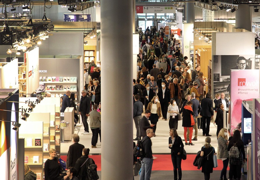 Visitors are pictured at the Frankfurt Book Fair at the Messe fairground in Frankfurt am Main, western Germany, on October 20, 2022. - AFP PIC