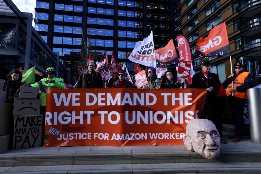 Protestors gather outside the Amazon headquarters during Black Friday in London, Britain. - REUTERS PIC