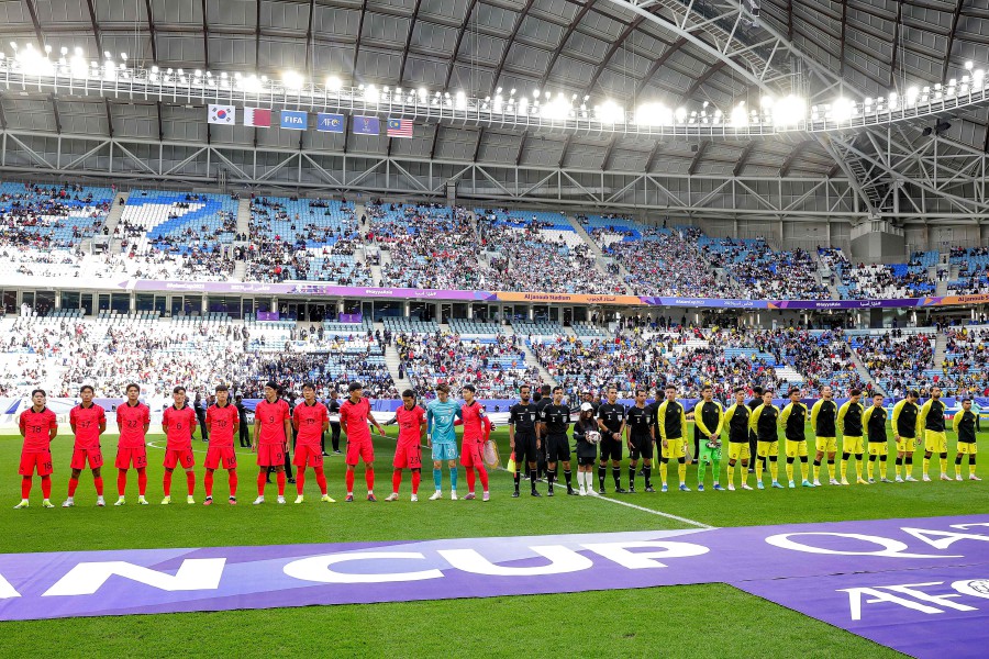 Malaysia's players (R) and South Korea's players stand for their national anthems before the start of the Qatar 2023 AFC Asian Cup Group E football match between South Korea and Malaysia at Al-Janoub Stadium in al-Wakrah. - AFP PIC