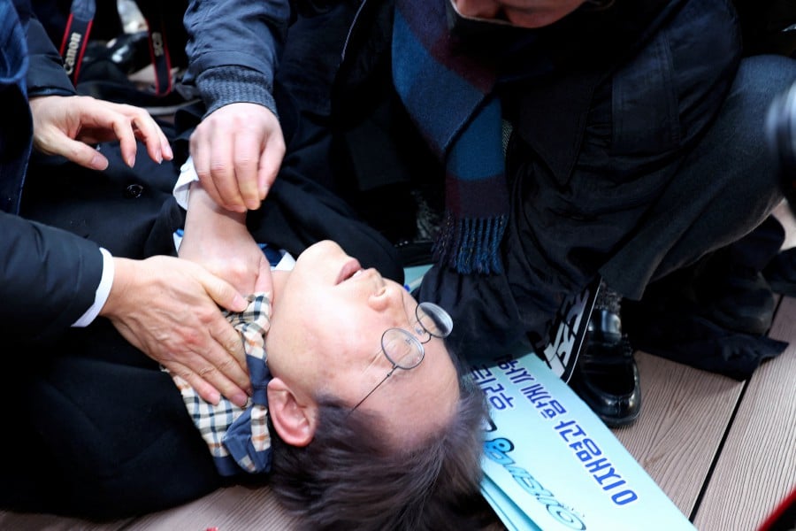 South Korea's opposition party leader Lee Jae-myung falls after being attacked by an unidentified man during his visit to Busan, South Korea. - REUTERS PIC