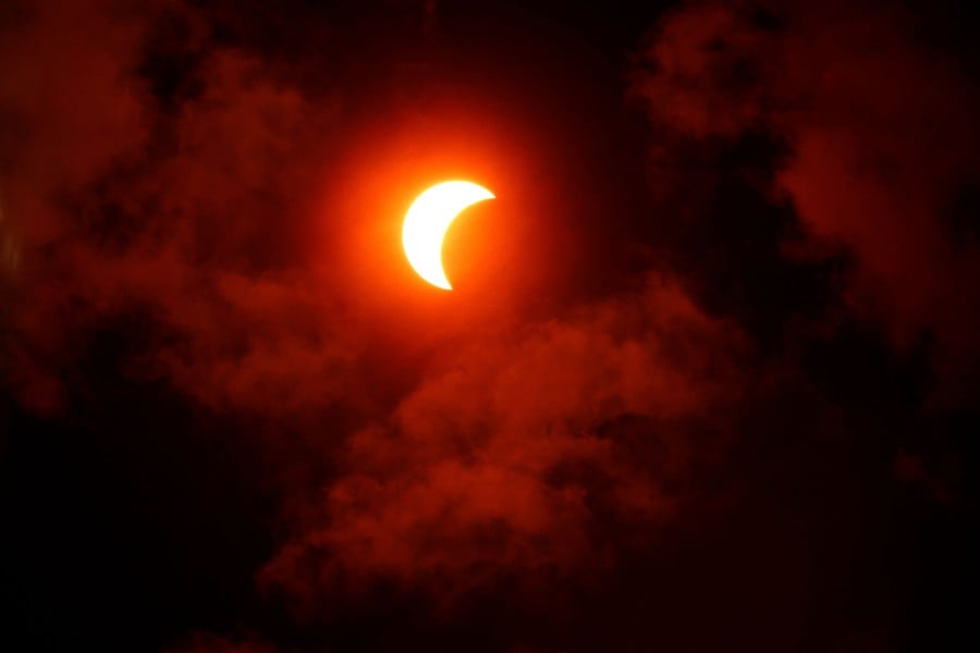 The solar eclipse is seen above the National Mall on April 08, 2024 in Washington, DC. - AFP PIC