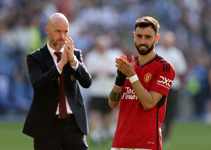 Manchester United's Bruno Fernandes and manager Erik ten Hag applaud fans after the match.- REUTERS PIC