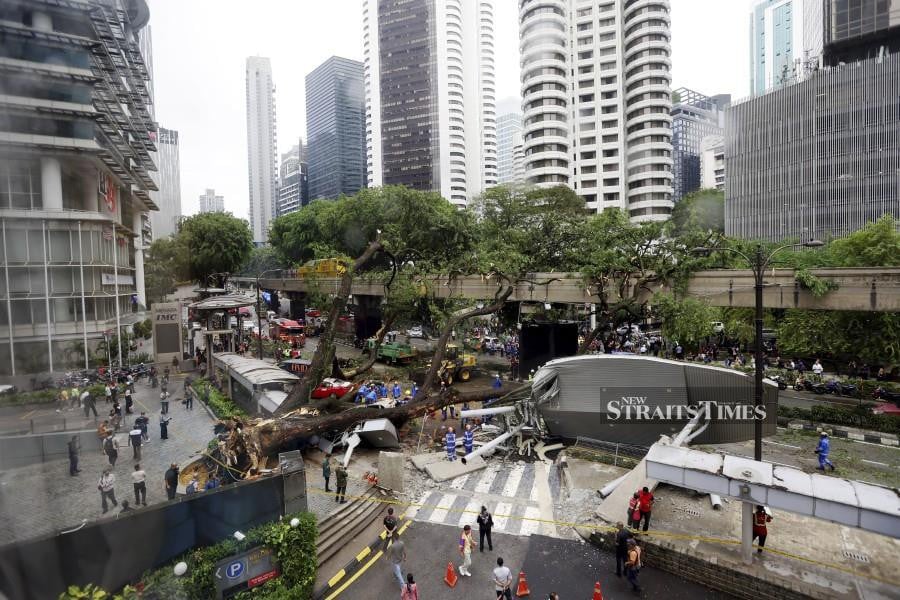 This May 7 pic shows the uprooted tree at Jalan Sultan Ismail. -NSTP/ASWADI ALIAS