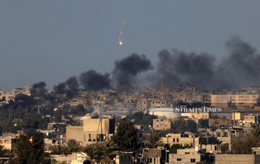 This photograph taken on January 15, 2024 from Rafah shows smoke billowing over Khan Yunis in the southern Gaza Strip. - AFP PIC