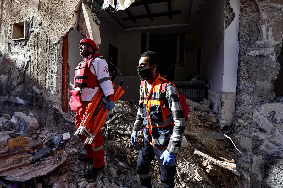 Rescuers check the damage of a house following an Israeli raid in the occupied West Bank city of Jenin. - AFP PIC