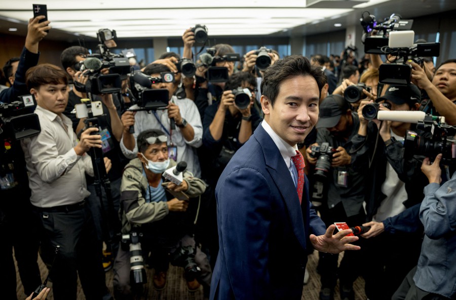 Former Thai prime ministerial candidate and Move Forward Party MP Pita Limjaroenrat (C) arrives to speak to media at the Thai parliament in Bangkok. - AFP PIC