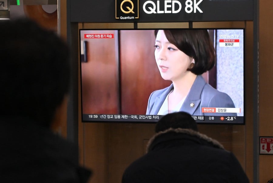 People watch a television screen showing a news broadcast with a file footage of South Korean ruling People Power Party's lawmaker Bae Hyun-jin, at a railway station in Seoul. - AFP PIC