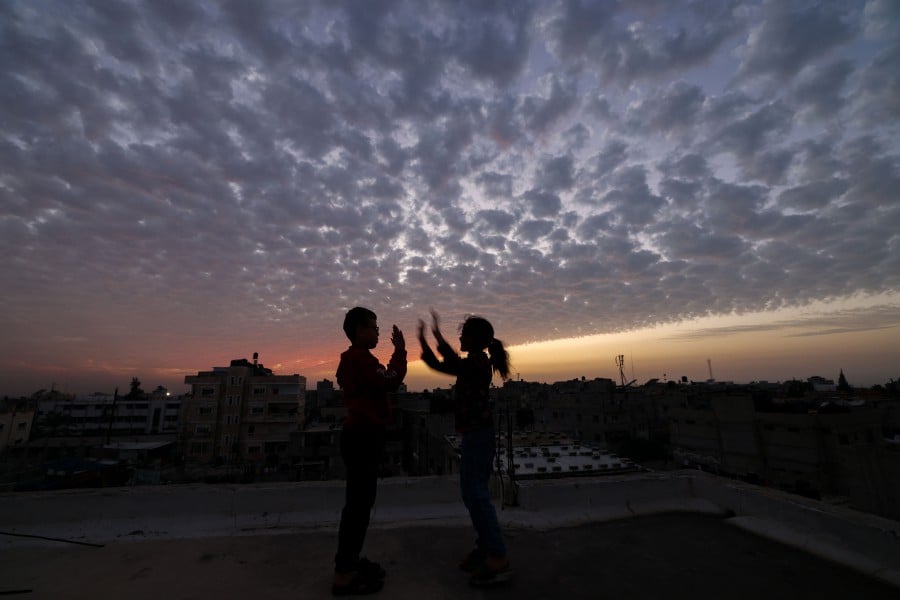 Children play on the roof of a building in Rafah, on the southern Gaza Strip. - AFP PIC