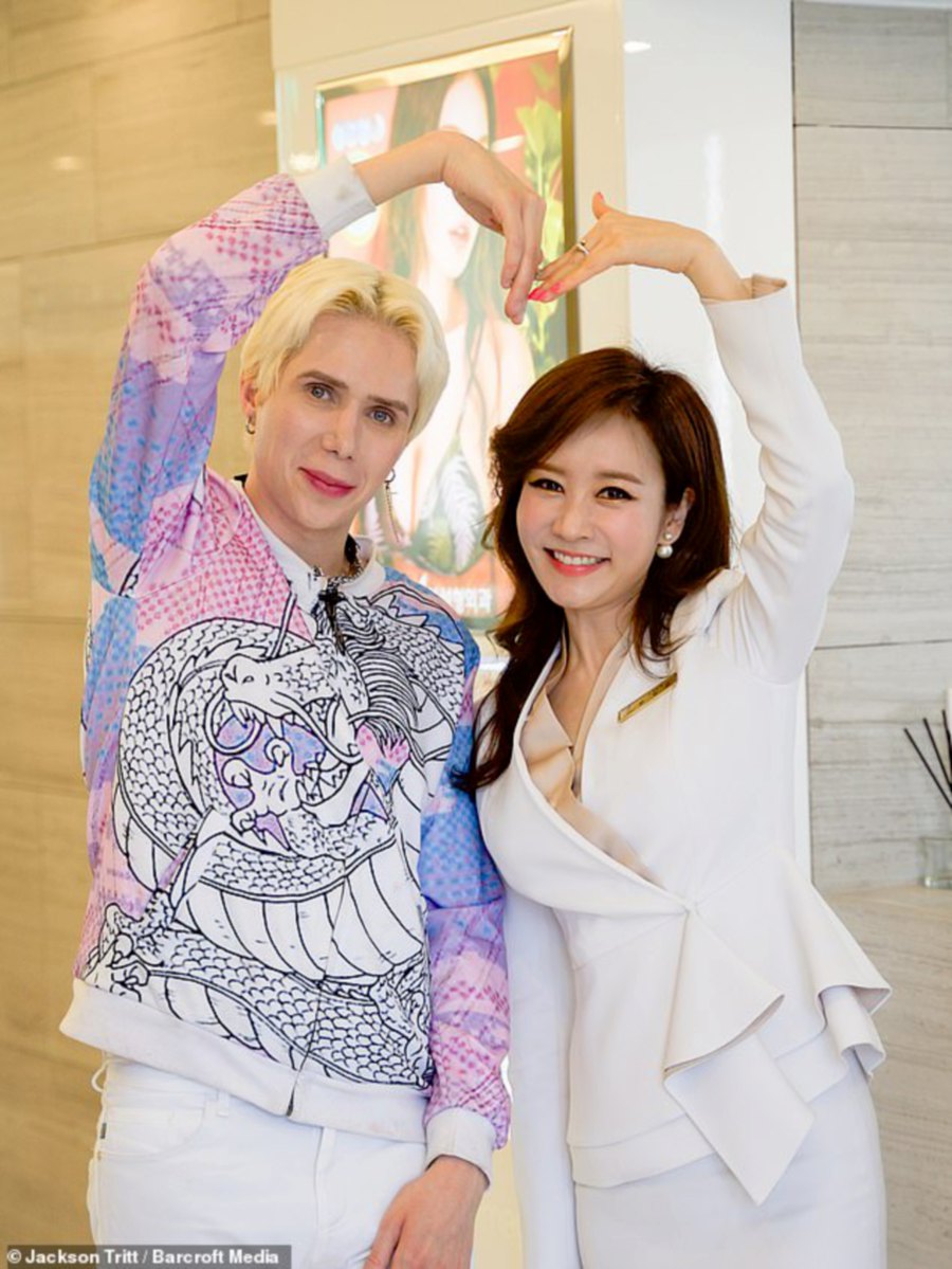Oli has even released a K-Pop music video which he said is 'like a dream come true.' Pictured at View Plastic Surgery Clinic with a member of staff. Pic courtesy of DAILY MAIL