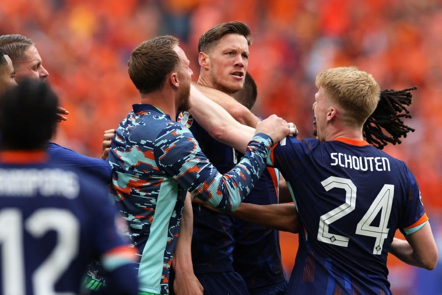 Netherlands' forward Wout Weghorst (C) celebrates with teammates after scoring his team's second goal during the UEFA Euro 2024 Group D football match between Poland and the Netherlands at the Volksparkstadion in Hamburg. - AFP— PIC