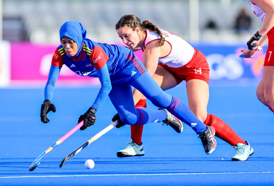 Malaysia (in blue) in action against Canada in the Olympic Qualifier in Valencia on Sunday.