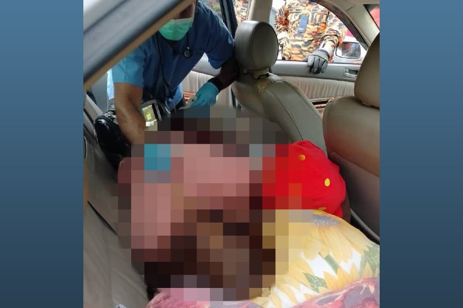 A woman was found dead in a locked vehicle at a parking lot near the Specialist Clinic of Hospital Raja Permaisuri Bainun here today. - Pic courtesy from Fire & Rescue Dept