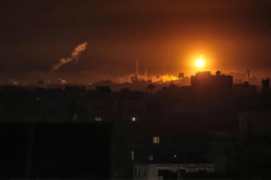 Israeli bombardment lights the skyline of Khan Yunis, pictured from Rafah in the southern Gaza Strip. - AFP PIC