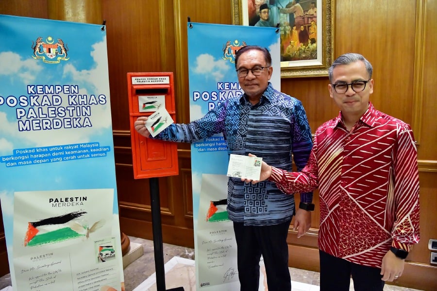 Prime Minister Datuk Seri Anwar Ibrahim and Communications Minister Fahmi Fadzil during the Special Postcard Campaign for Palestinian Independence. - Pic credit Facebook Fahmi.Fadzil.1 