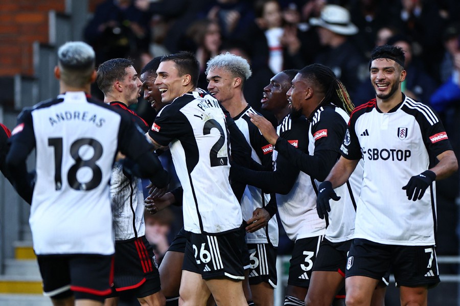 Fulham's Tosin Adarabioyo (3L) celebrates with teammates after scoring their third goal during the English Premier League football match between Fulham and West Ham United at Craven Cottage in London. - AFP PIC