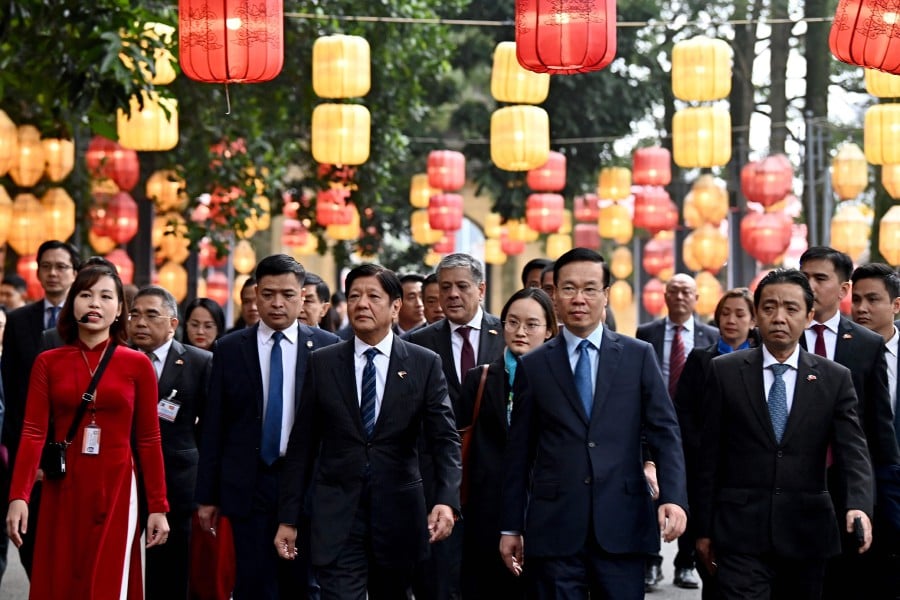 Philippine President Ferdinand Marcos (centre L) and Vietnam's President Vo Van Thuong (centre R) visit Thang Long Imperial Citadel in Hanoi. - AFP PIC